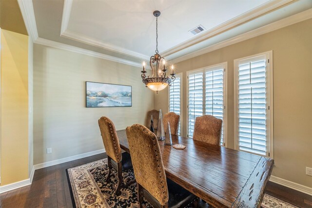 dining room featuring visible vents, baseboards, dark wood-type flooring, crown molding, and a raised ceiling