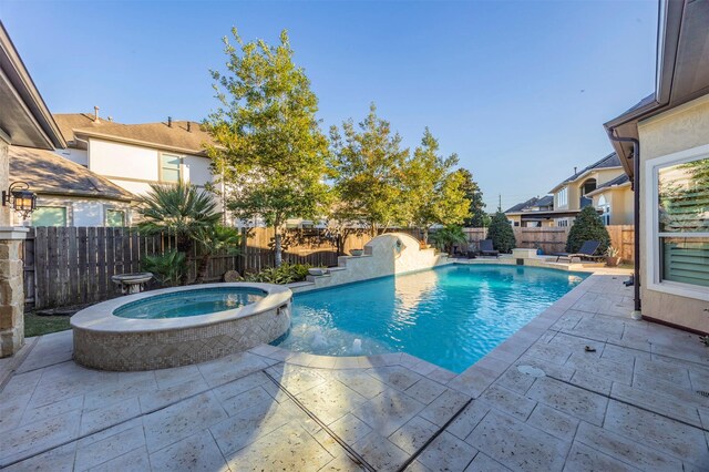 view of swimming pool featuring a patio, a fenced backyard, and a pool with connected hot tub