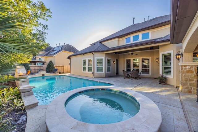 view of pool featuring a patio, a pool with connected hot tub, a ceiling fan, and fence