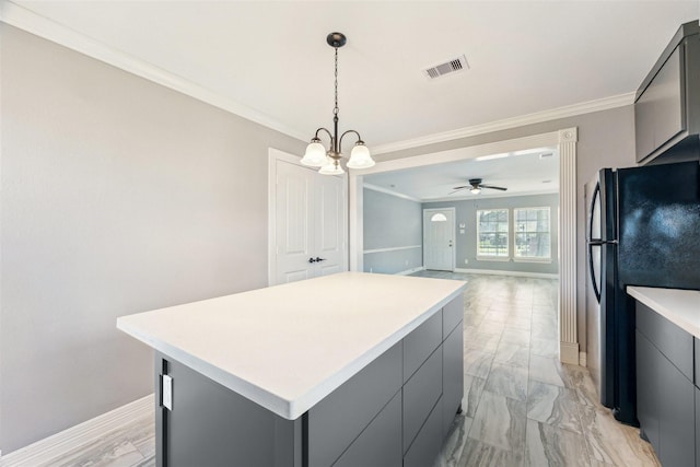 kitchen featuring freestanding refrigerator, visible vents, and gray cabinetry