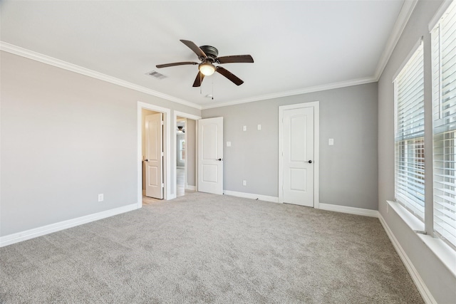 unfurnished bedroom featuring light carpet, baseboards, visible vents, and ornamental molding