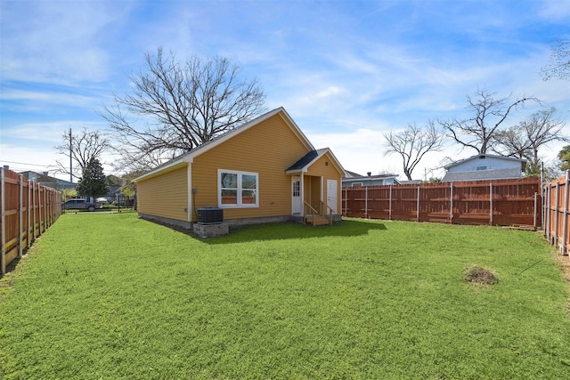 back of house featuring a fenced backyard and a yard