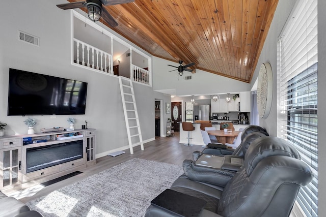 living room featuring light wood-type flooring, wooden ceiling, visible vents, and a ceiling fan