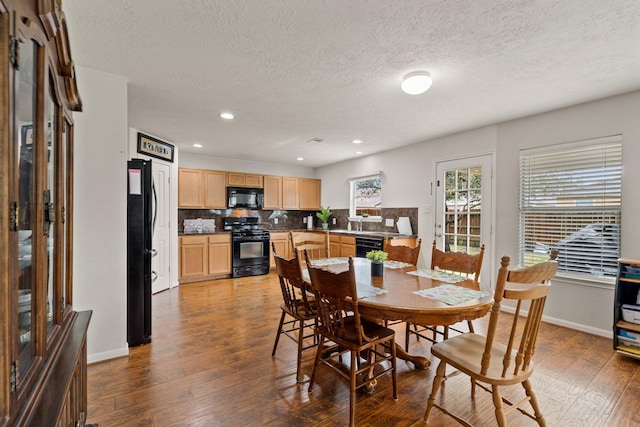 dining area with baseboards, wood finished floors, and recessed lighting