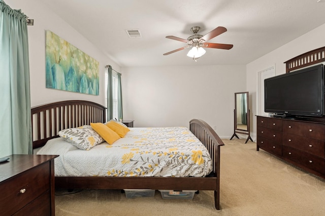 bedroom featuring ceiling fan, visible vents, and light colored carpet