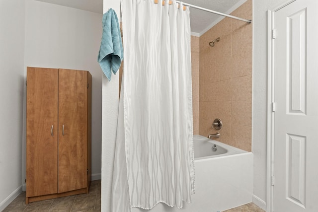 bathroom featuring shower / bath combo, baseboards, and tile patterned floors