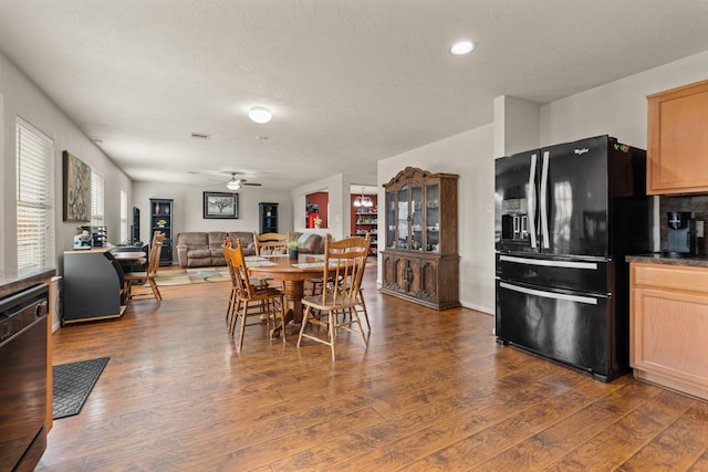 dining room featuring dark wood-style floors, a textured ceiling, and a ceiling fan