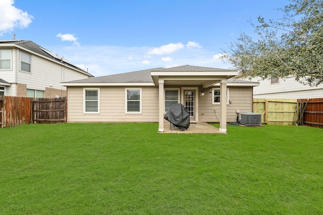 back of house featuring a fenced backyard, central AC, a patio, and a yard