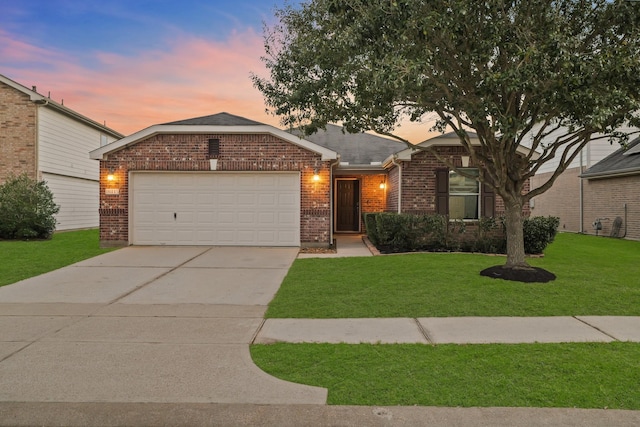 single story home with brick siding, roof with shingles, a lawn, an attached garage, and driveway