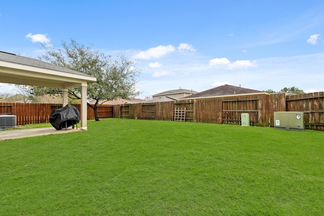 view of yard featuring central AC and a fenced backyard