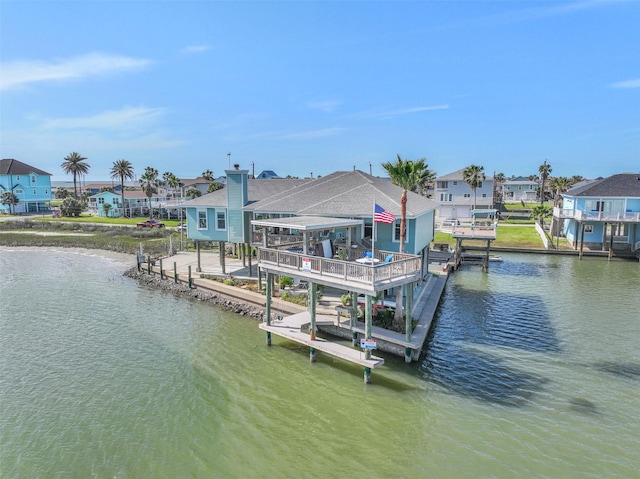 view of dock with a water view and a residential view