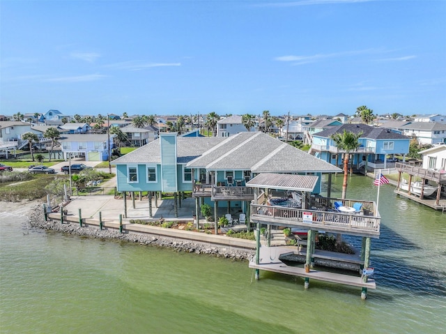 view of dock with a residential view and a deck with water view