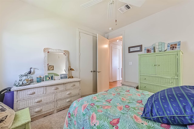 bedroom with carpet, visible vents, and ceiling fan