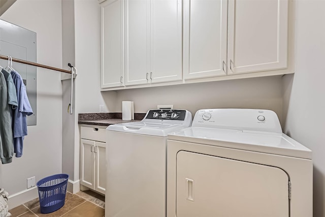 laundry area featuring baseboards, tile patterned flooring, cabinet space, and washer and dryer