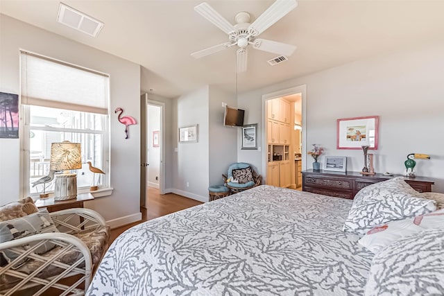 bedroom with visible vents, ceiling fan, baseboards, and wood finished floors