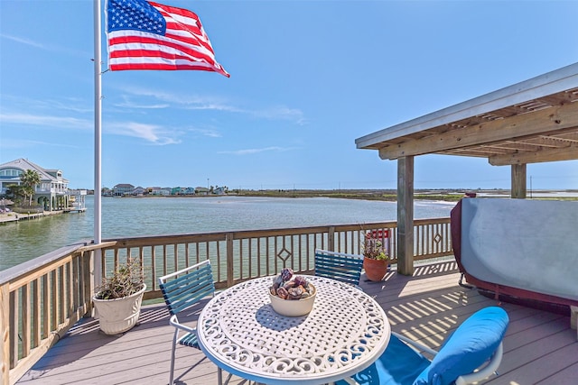 wooden deck featuring outdoor dining area and a water view