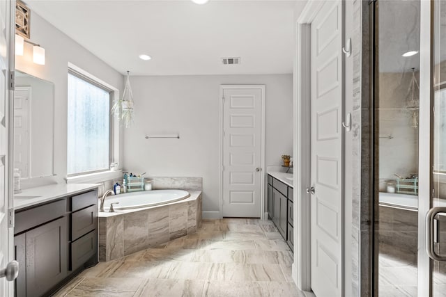 full bath featuring a shower stall, visible vents, a bath, and vanity