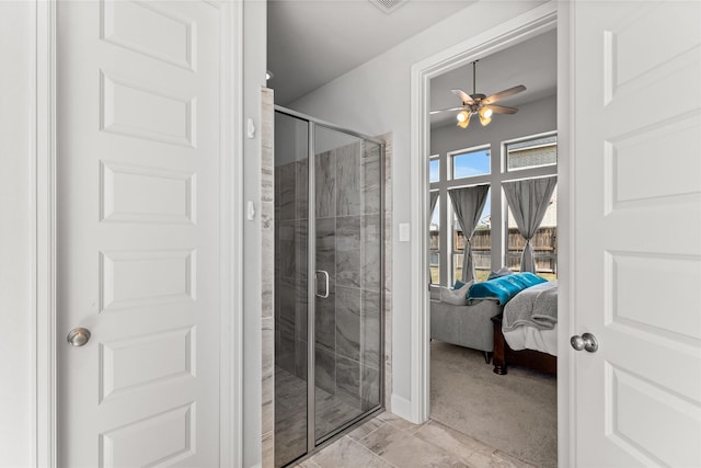 bathroom with a stall shower, ceiling fan, and ensuite bath