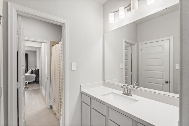 bathroom with tile patterned flooring and vanity