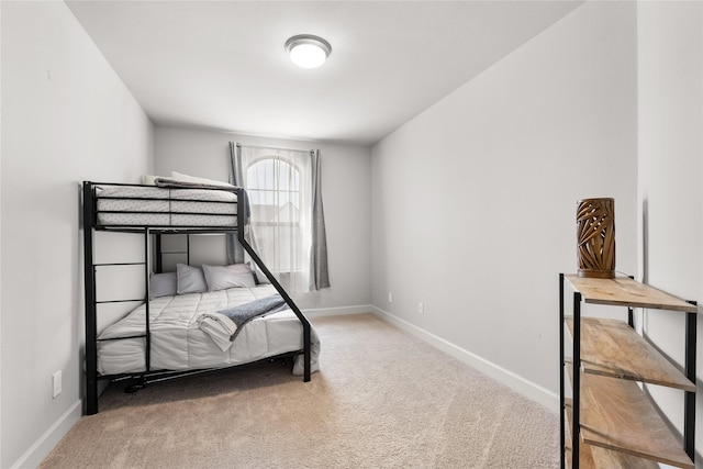 bedroom with carpet and baseboards