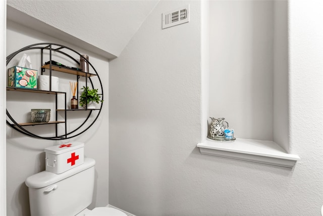 bathroom featuring toilet and visible vents