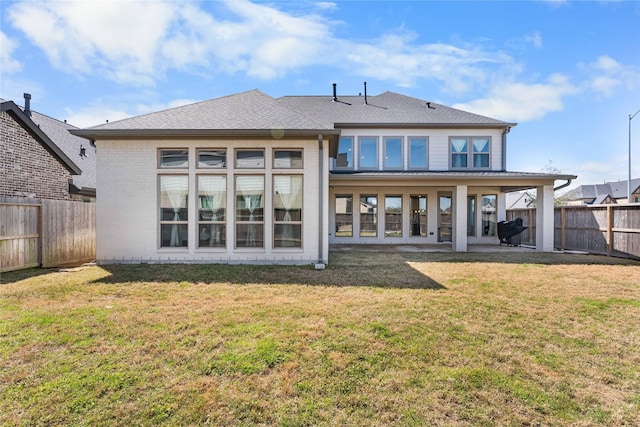 back of property with a patio area, a fenced backyard, and a yard