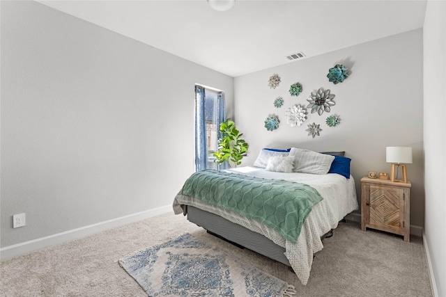 carpeted bedroom featuring visible vents and baseboards