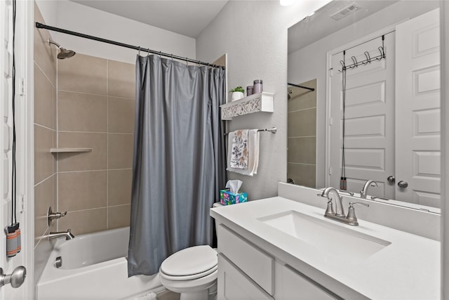 bathroom with visible vents, a textured wall, vanity, and toilet