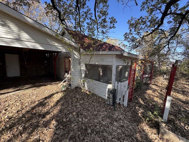 view of home's exterior with a sunroom