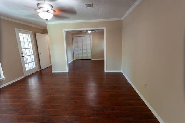 empty room with dark wood-style floors, ornamental molding, and visible vents