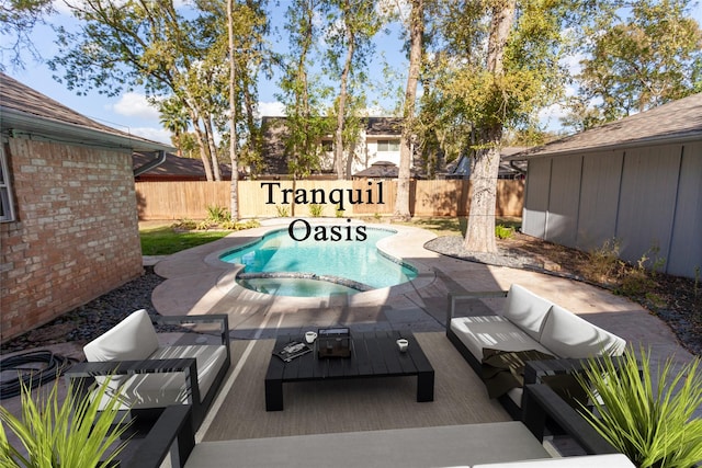 view of swimming pool featuring a patio area, a fenced backyard, and a pool with connected hot tub