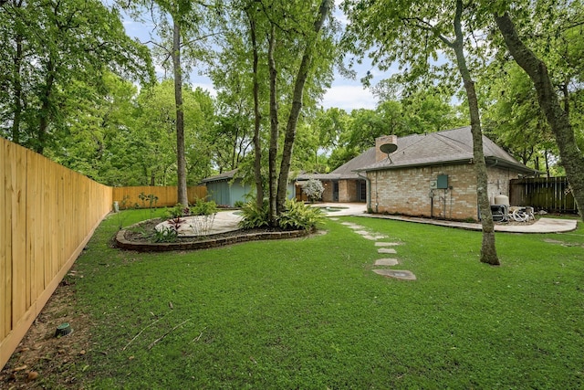 view of yard featuring a patio area and a fenced backyard