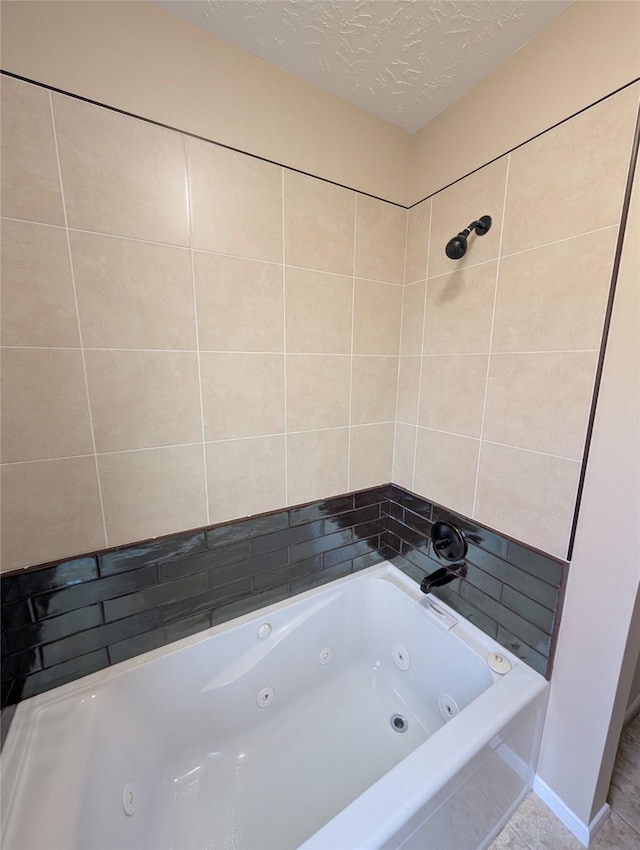 full bathroom with a combined bath / shower with jetted tub and a textured ceiling