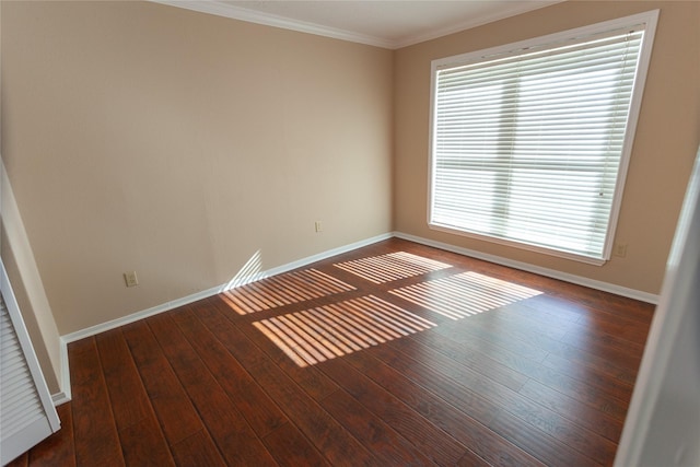 unfurnished room with ornamental molding, hardwood / wood-style flooring, and baseboards