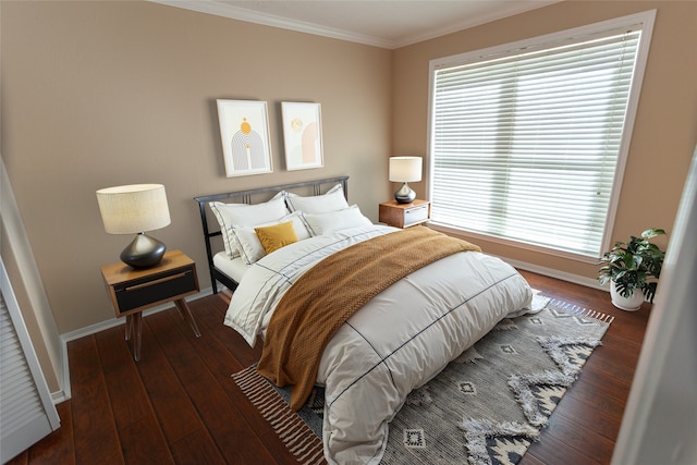 bedroom featuring baseboards, hardwood / wood-style floors, and crown molding