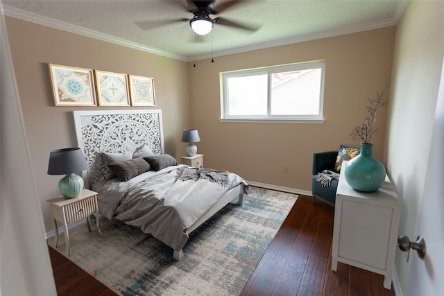 bedroom with dark wood-style floors, ornamental molding, baseboards, and ceiling fan