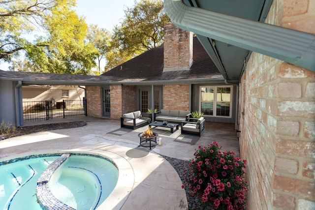 exterior space with a pool with connected hot tub, fence, an outdoor hangout area, and a patio