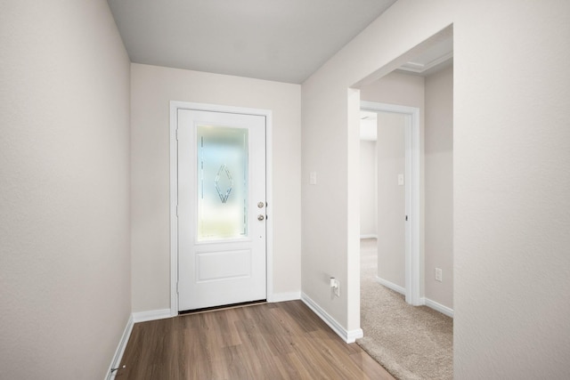 entryway featuring baseboards and wood finished floors