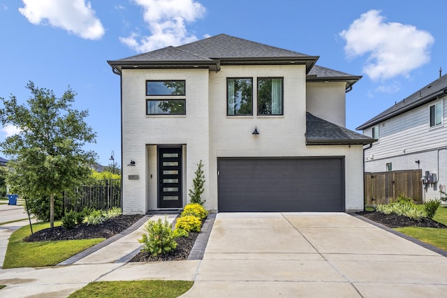 view of front of property with an attached garage, roof with shingles, fence, and brick siding