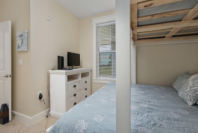 bedroom featuring tile patterned flooring and baseboards