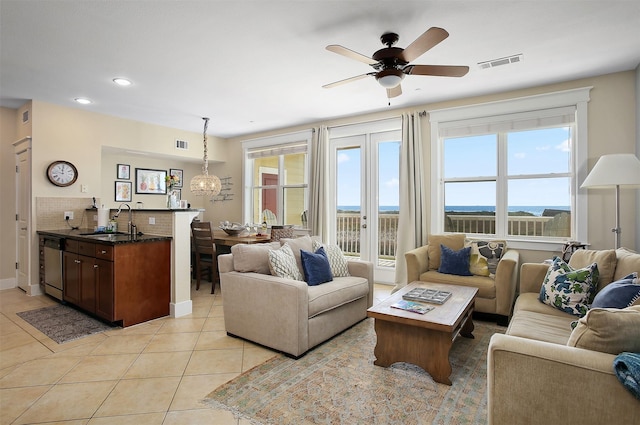 living room with recessed lighting, visible vents, light tile patterned flooring, and ceiling fan with notable chandelier