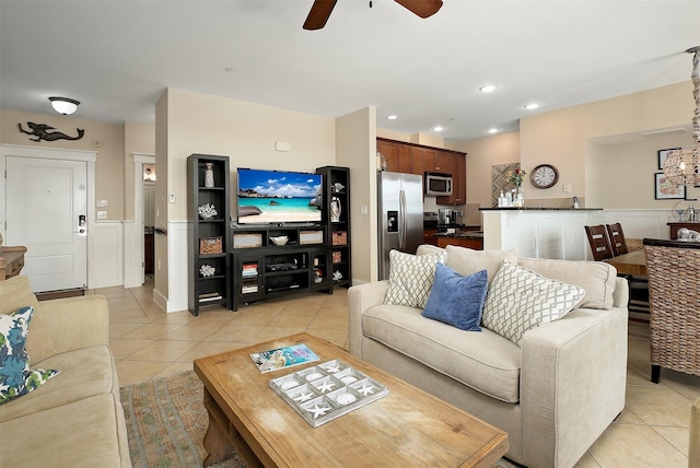 living room with light tile patterned floors, a wainscoted wall, a ceiling fan, and recessed lighting