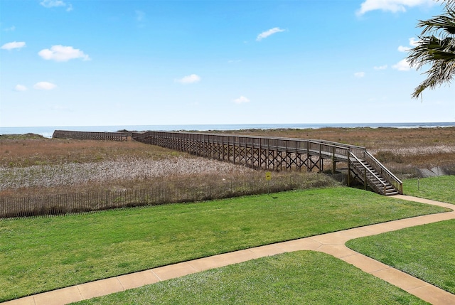 view of yard featuring stairs and a water view