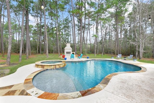 view of pool with a pool with connected hot tub, a lawn, an outdoor stone fireplace, and a patio area