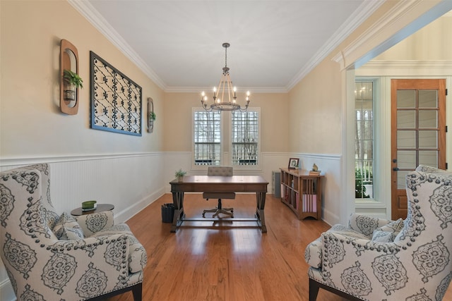 office area featuring crown molding, wood finished floors, a chandelier, and wainscoting