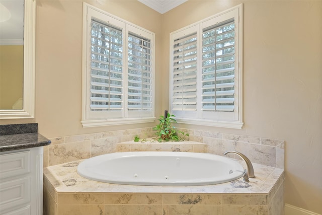 bathroom featuring a wealth of natural light, vanity, a garden tub, and ornamental molding