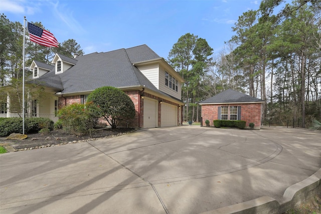 view of front facade featuring concrete driveway, a garage, brick siding, and a shingled roof