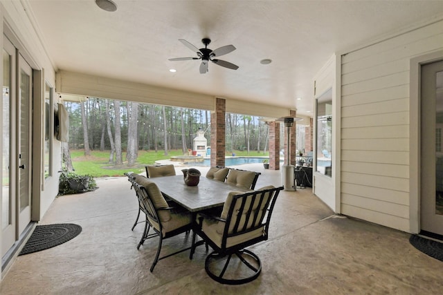 sunroom featuring a ceiling fan and a wealth of natural light