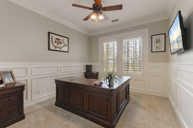 office area with visible vents, ceiling fan, ornamental molding, light carpet, and a decorative wall