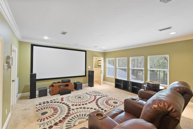 carpeted home theater featuring visible vents, baseboards, and ornamental molding